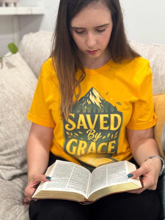 Religious t-shirt with a powerful "Saved by Grace" design and Bible illustration