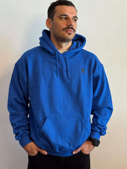 Man wearing a blue hoodie against a plain background