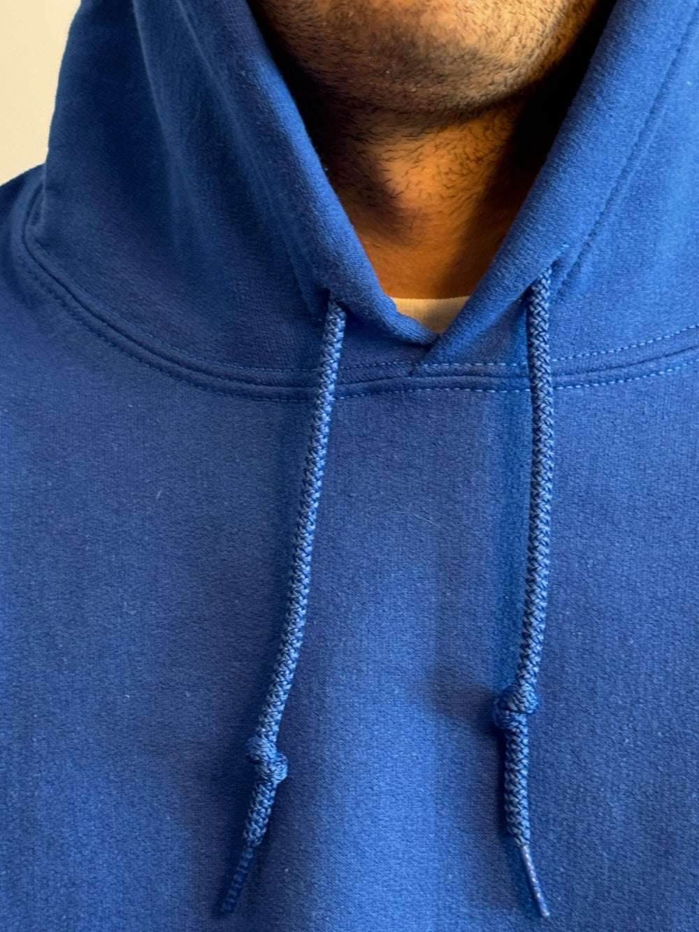 Close-up of a blue hoodie with a blurred background