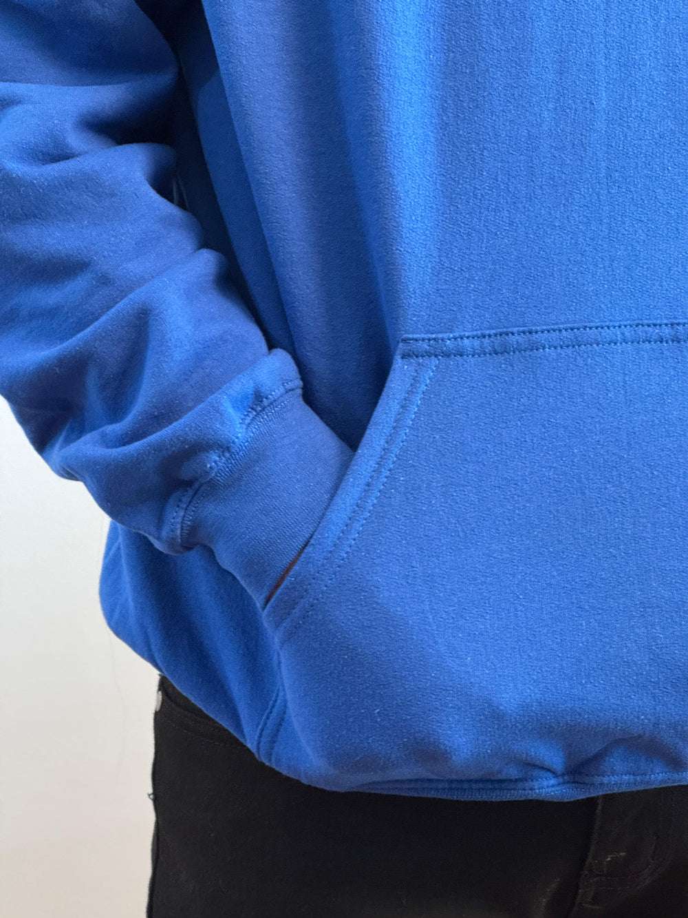 Close-up of a blue hoodie with a white background