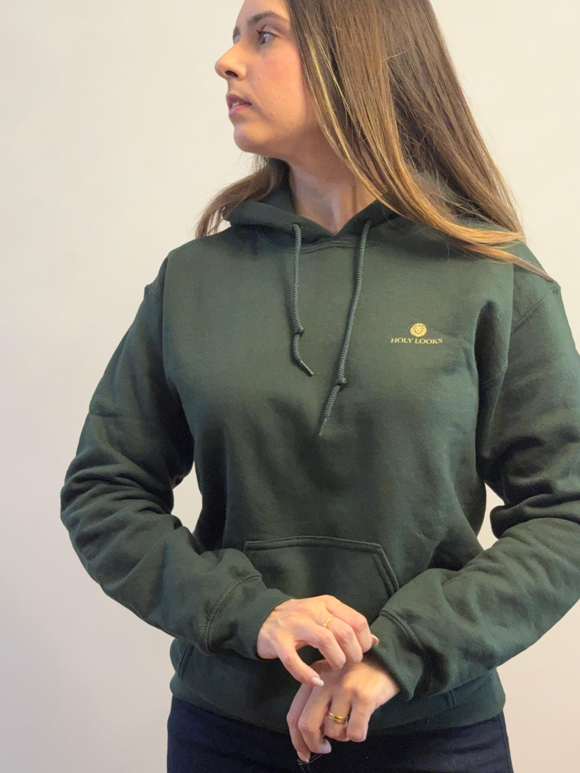Person wearing a green hoodie with a logo on a plain background
