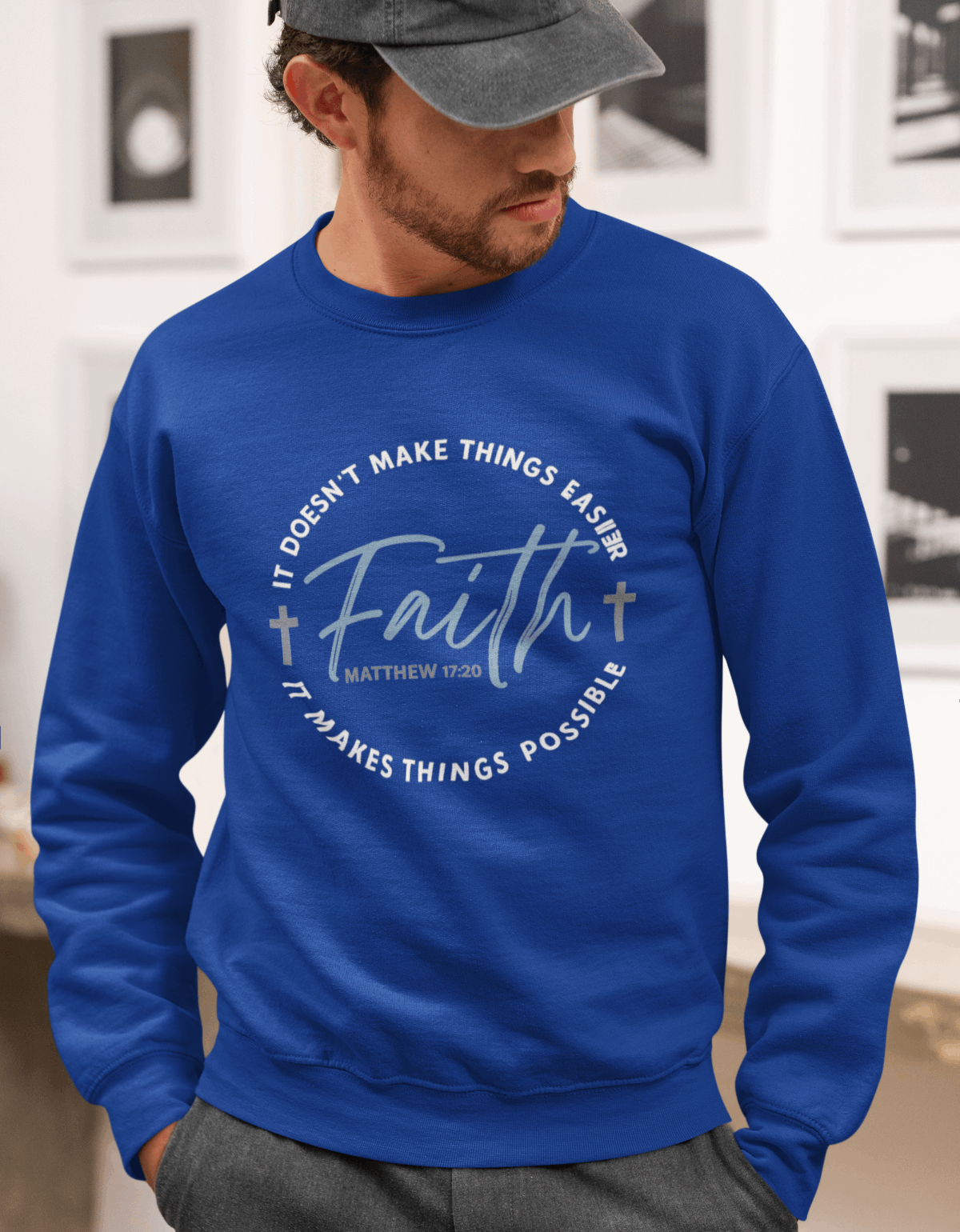 Man wearing a blue sweatshirt with motivational text in an indoor setting